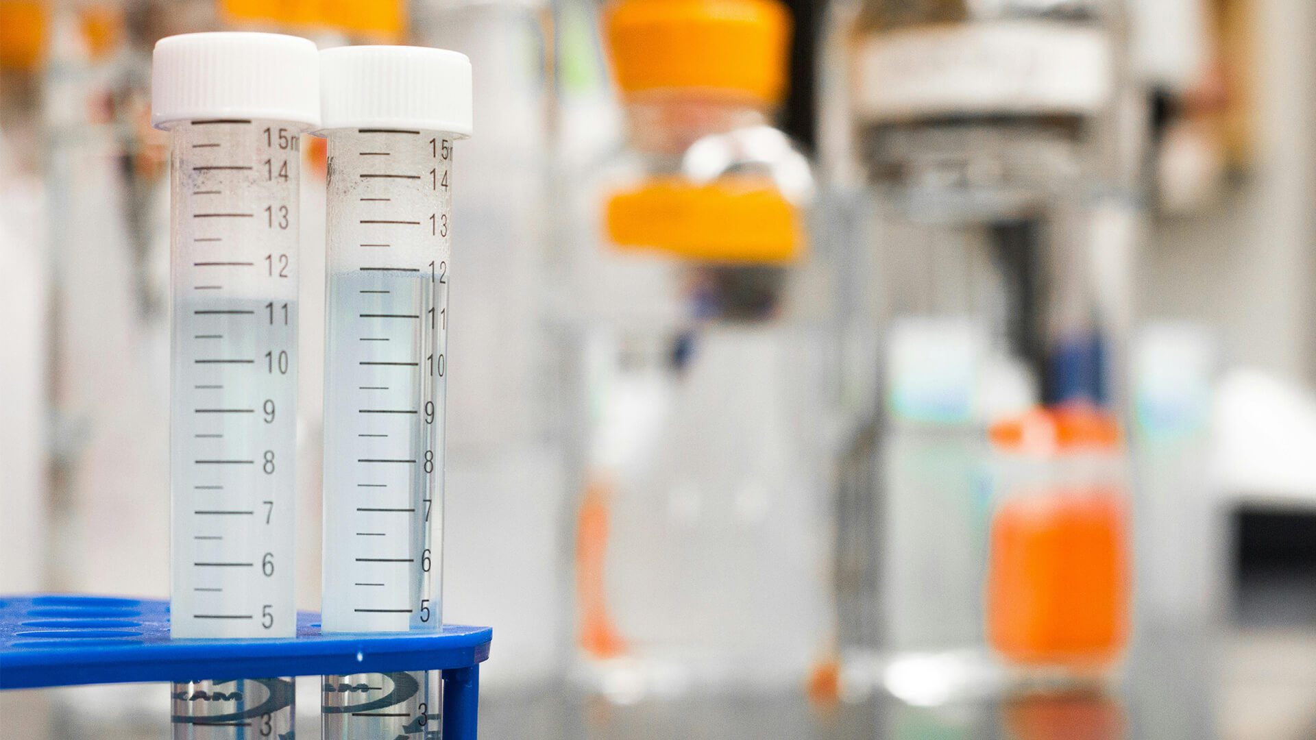 Closeup of two test tubes in stand inside of lab.