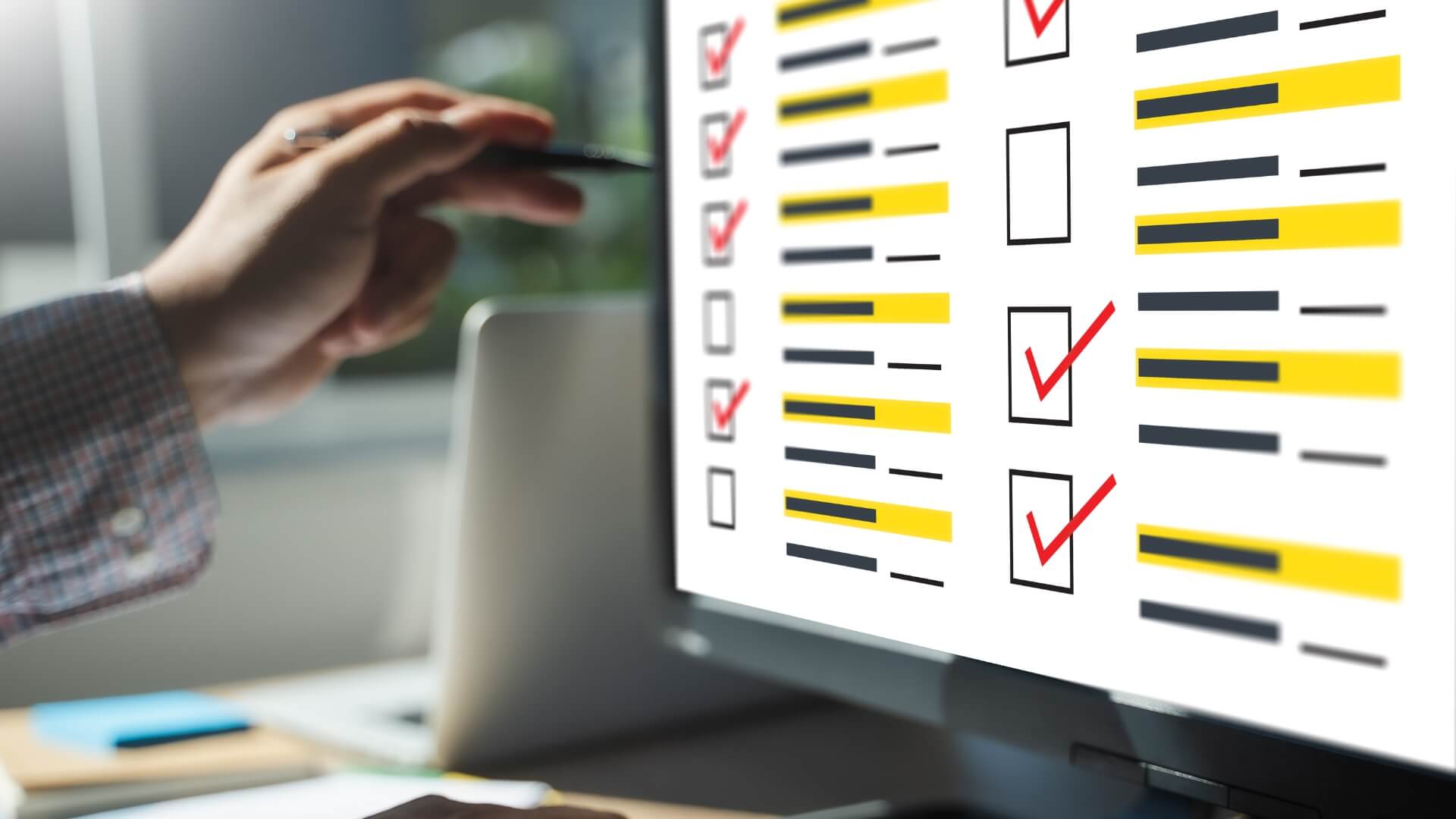 Person marking work on computer.