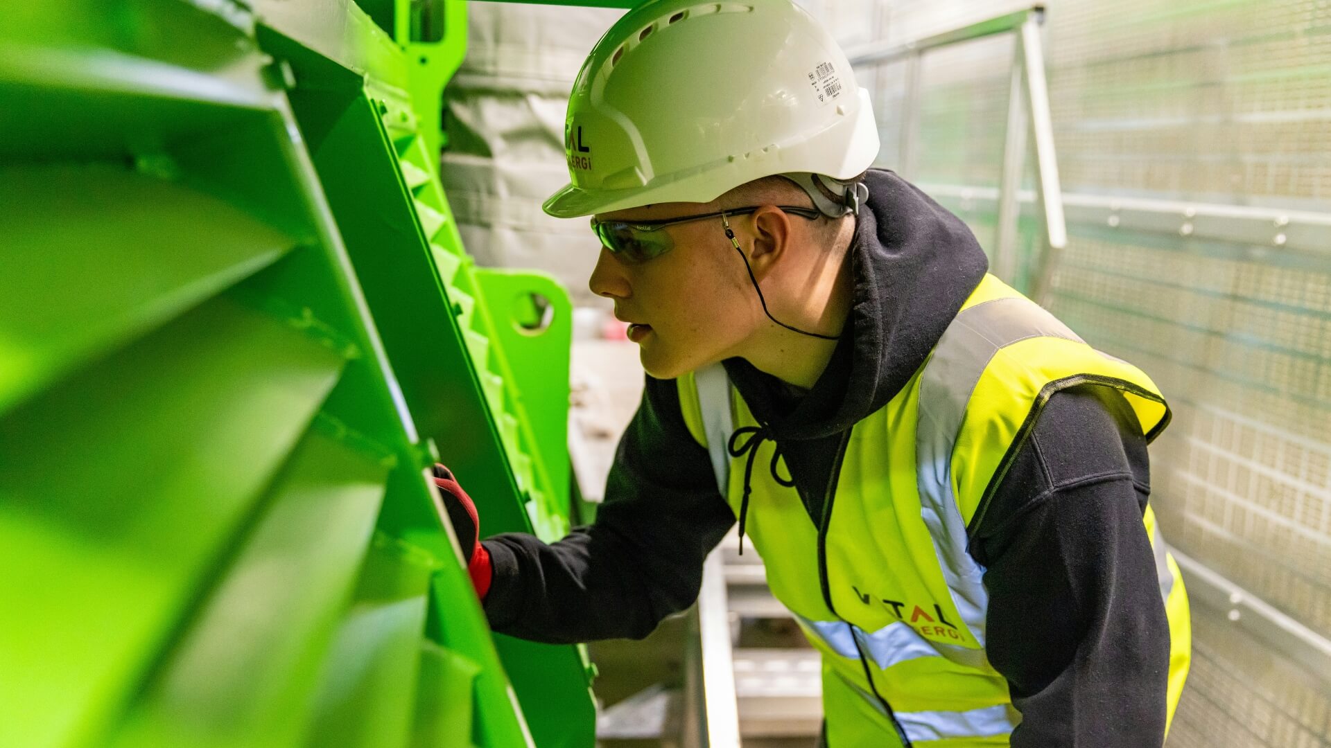 Engineer working in a high vis vest and hardhat.