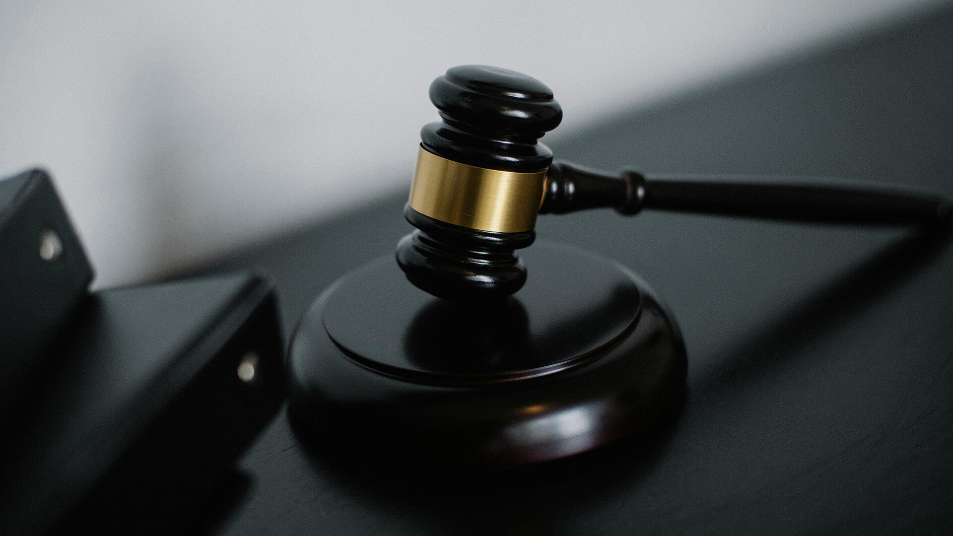 A Judges gavel on a black background.