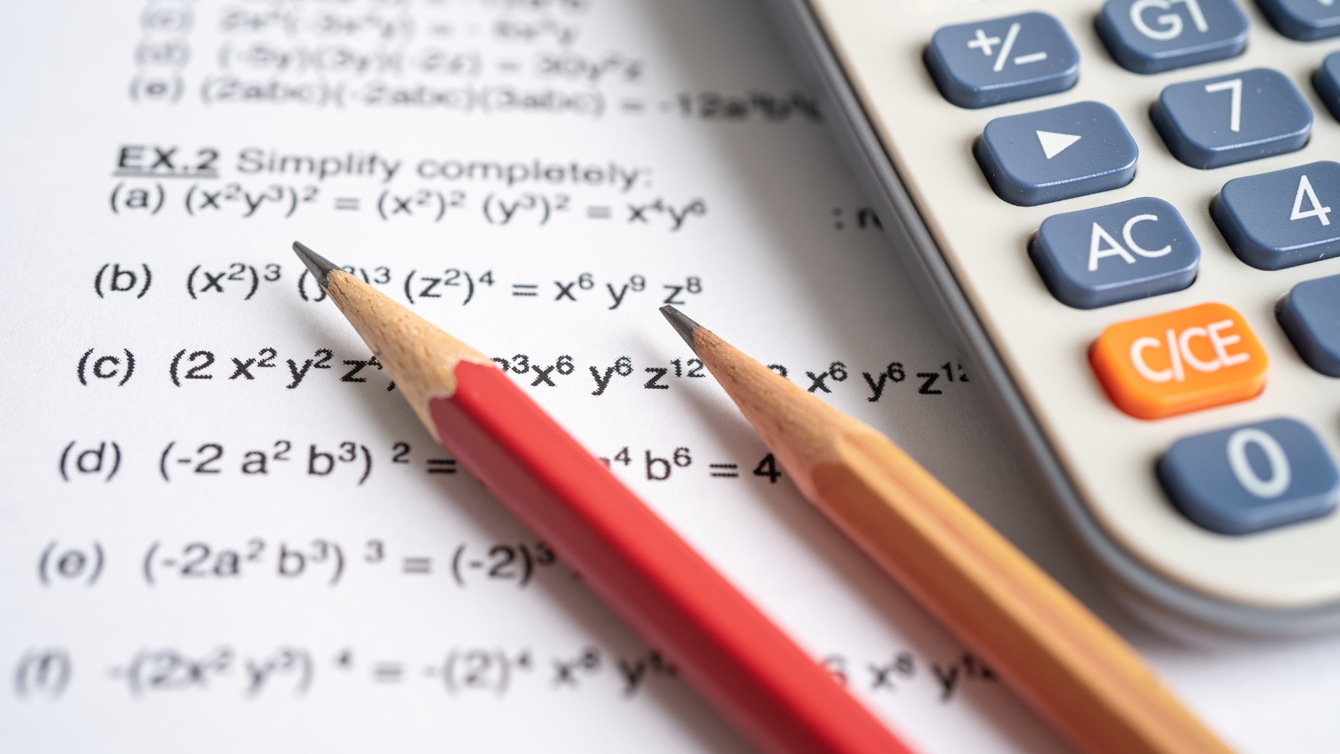 Pencil resting on page of maths equations.