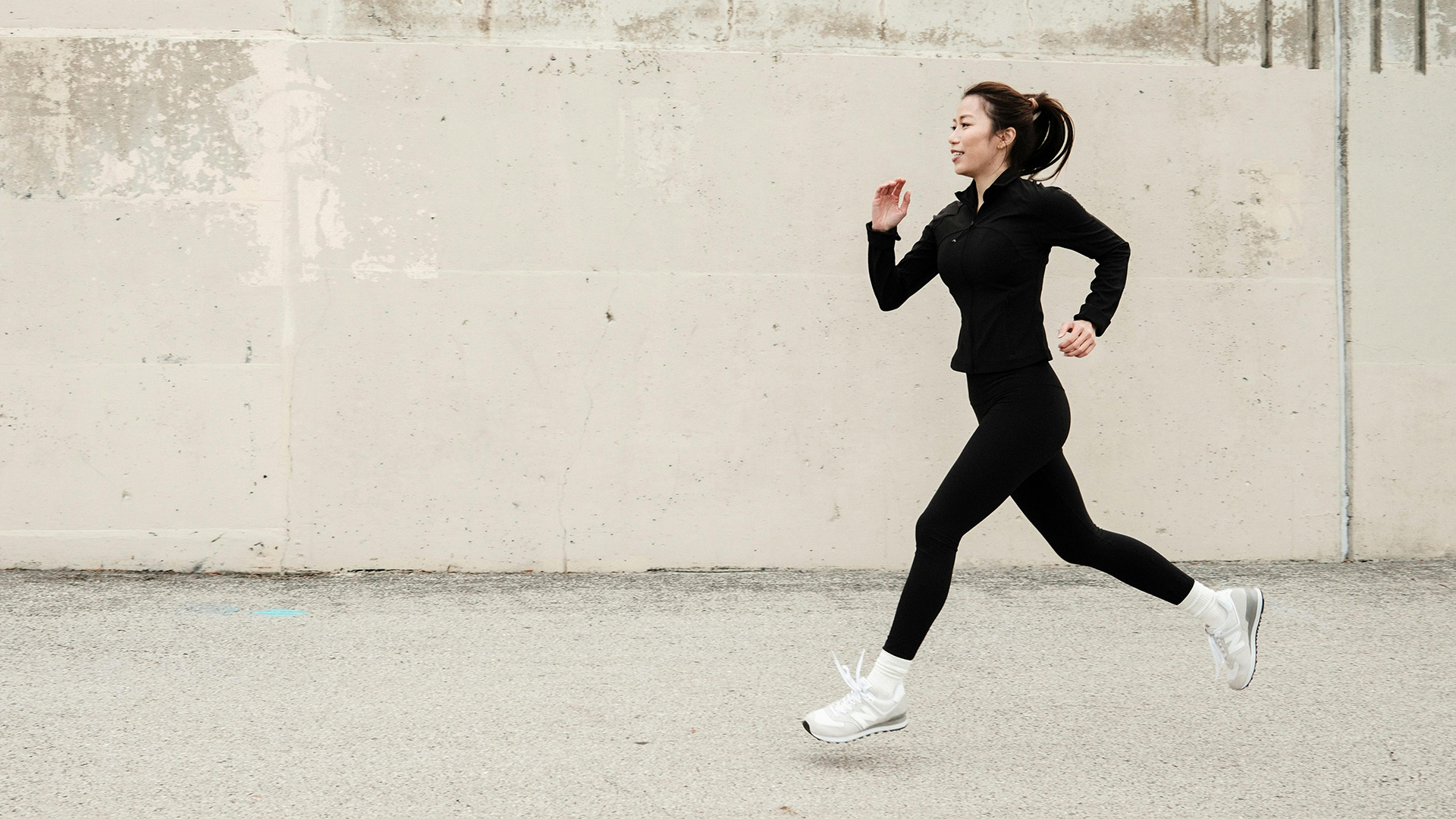 Young woman jogging on wooden boards