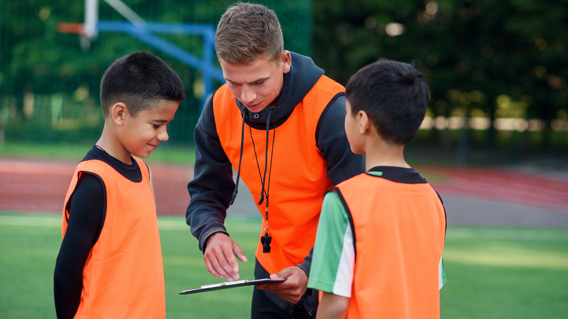 Coach giving advice to kids.