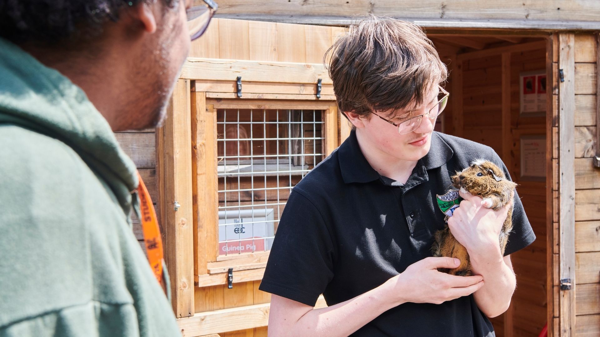 Student holding guinea pig