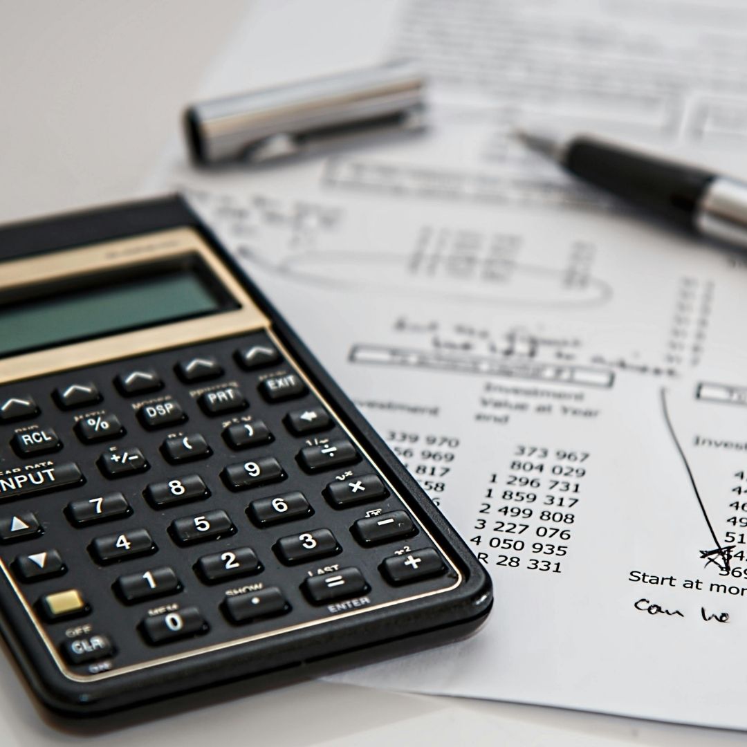Calculator and workbook on desk