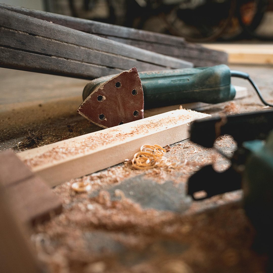 Carpentry tools and wood lying on floor.