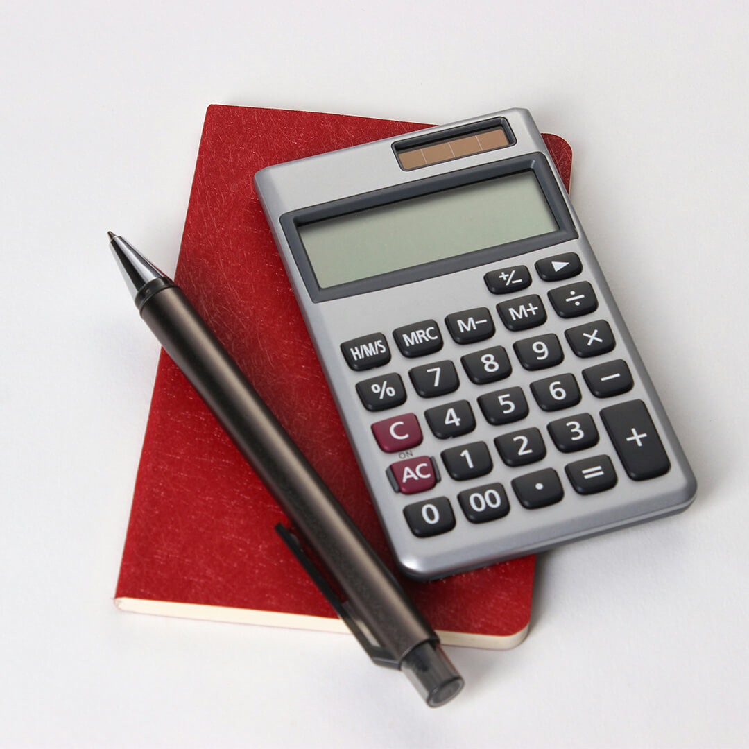 Red notepad, pen and calculator.