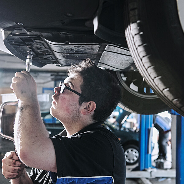 Man working on the underneath of a car.