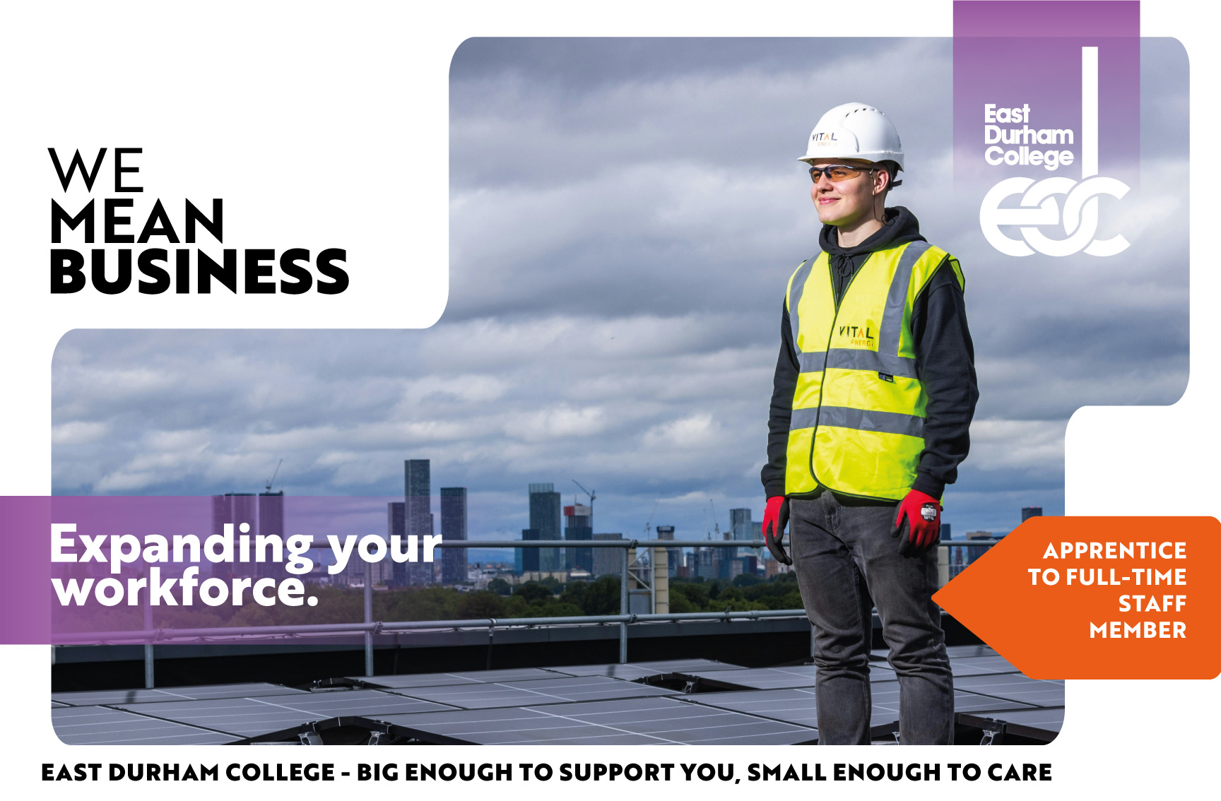 Male engineer in high vis and hard hat standing near solar panels