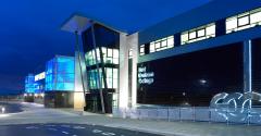 Exterior of East Durham College's Peterlee campus building lit up at night