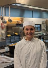 Catering student stood in kitchen