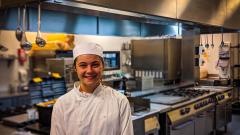 Catering student stood in kitchen in chef whites