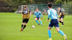 Football match with four players in action