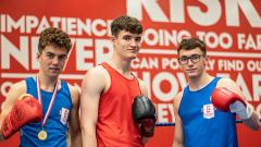 A group of three boxers posing for camera 