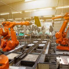 Robotic arms working in manufacturing environment