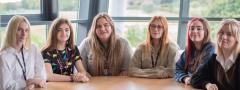 A group of six young ED6 students sat round a table