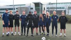 Jermain Defoe standing with students outside of East Durham College