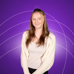 Smiling female student in white top and cardigan against purple background