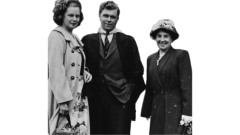 George standing with his girlfriend and mother