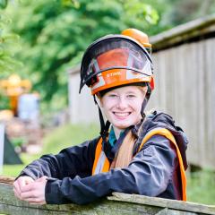 Arboriculture student wearing gear smiling at camera