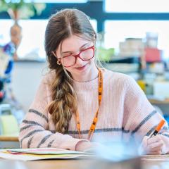 Student drawing in art classroom