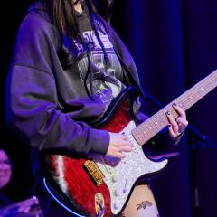 Close up of student playing guitar