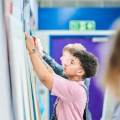 Student measuring wall