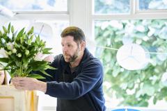Adult male arranging flowers