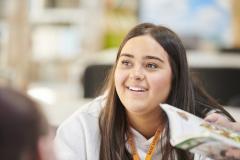 Female student smiling to someone off camera