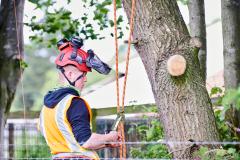Student wearing climbing gear tying rope